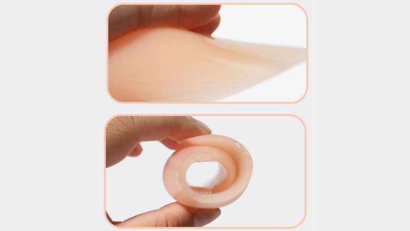 Close-up of a silicone shoulder pad showing its soft texture, adhesive surface and strong elasticity when stretched and folded.
