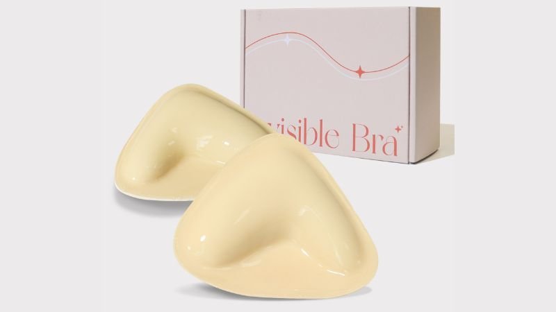 Skin-tone silicone breast enhancer inserts displayed with retail packaging for invisible bra products