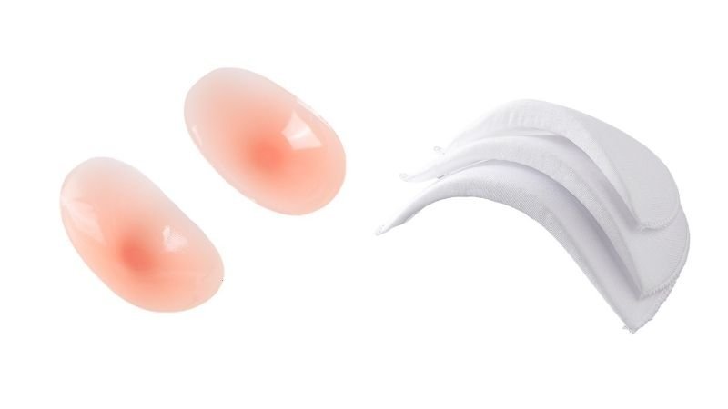 Comparison of reusable silicone shoulder pads and traditional garment shoulder pads, showing the difference between removable shoulder shaping accessories and conventional padded inserts.