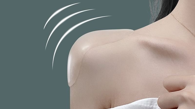Woman wearing reusable silicone shoulder pads to improve the appearance of sloping shoulders and create a more balanced shoulder silhouette.